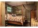 This charming bedroom features a floral bedspread and a decorative four-poster bed frame at 3959 Central Ave, Indianapolis, IN 46205