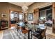 Chic dining room with a glass-top table and chandelier, situated near an open bedroom and living area at 3959 Central Ave, Indianapolis, IN 46205