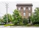 Brick building featuring symmetrical windows, decorative stone accents and mature trees at 3959 Central Ave, Indianapolis, IN 46205
