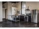 Studio kitchen featuring stainless steel appliances, granite countertops, and an exposed brick accent wall at 3959 Central Ave, Indianapolis, IN 46205