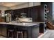 Modern kitchen featuring dark cabinets, a center island with seating, and stainless steel appliances at 3959 Central Ave, Indianapolis, IN 46205