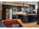 Sleek kitchen featuring dark cabinetry, stainless steel appliances, and a large island with room for seating at 3959 Central Ave, Indianapolis, IN 46205