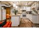 A modern kitchen features stainless appliances, a white island, and adjacent seating in a finished basement at 3959 Central Ave, Indianapolis, IN 46205