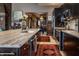 Contemporary kitchen with stainless steel appliances, island seating, and a view into other living spaces at 3959 Central Ave, Indianapolis, IN 46205