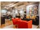 Finished basement area with dining and sitting areas, exposed ceiling pipes, and modern furnishings at 3959 Central Ave, Indianapolis, IN 46205