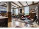 Open-concept living room with hardwood floors, paneled walls, a brick fireplace, and stylish seating at 3959 Central Ave, Indianapolis, IN 46205