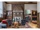 Living room with hardwood floors, paneled walls, a brick fireplace, and eclectic seating at 3959 Central Ave, Indianapolis, IN 46205