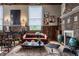 Cozy living room with hardwood floors, paneled walls, a brick fireplace, and eclectic seating at 3959 Central Ave, Indianapolis, IN 46205