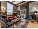 Living room with hardwood floors, wood-trimmed walls, a brick fireplace, and vintage-inspired decor at 3959 Central Ave, Indianapolis, IN 46205