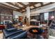 Expansive living room with a fireplace, coffered ceilings, and seamless flow to the modern kitchen at 3959 Central Ave, Indianapolis, IN 46205