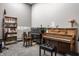 Inviting music room featuring two pianos, a dark upright, and a light wood console style with bench at 3959 Central Ave, Indianapolis, IN 46205