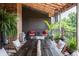 Charming patio with overhead covering, rustic wood table, and lush landscaping creates a relaxing outdoor space at 3959 Central Ave, Indianapolis, IN 46205