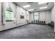 Bright studio space with wall-to-wall carpeting, multiple windows, and several seats for gathering at 3959 Central Ave, Indianapolis, IN 46205