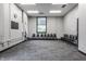 Bright studio space featuring carpeted flooring, several windows, and chairs for a gathering at 3959 Central Ave, Indianapolis, IN 46205