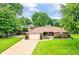 Sprawling property showcasing lush greenery, a long driveway, and a well-maintained brick home exterior at 4080 Wander Way, Greenwood, IN 46142