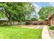 Spacious backyard with a basketball court, lush lawn, and privacy fence creating a private outdoor area at 4080 Wander Way, Greenwood, IN 46142