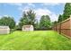 Well-maintained backyard with a shed and lush green lawn, perfect for outdoor activities at 4080 Wander Way, Greenwood, IN 46142