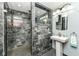 Modern bathroom with black marble tiling, sleek fixtures, and a glass-enclosed shower offer a spa-like experience at 4080 Wander Way, Greenwood, IN 46142