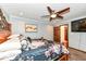 Spacious bedroom with modern accents, ceiling fan, a view of the outside, and a carpeted floor at 4080 Wander Way, Greenwood, IN 46142