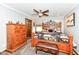 Cozy bedroom with wood furniture, ceiling fan, a view of the outside, and a carpeted floor at 4080 Wander Way, Greenwood, IN 46142