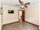 Neutral bedroom featuring hardwood-style floors, light tan walls, and a ceiling fan at 4080 Wander Way, Greenwood, IN 46142