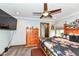 Relaxing bedroom with wood furniture, ceiling fan, a view of the outside, and a carpeted floor at 4080 Wander Way, Greenwood, IN 46142
