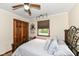 Bedroom with carpet flooring and a ceiling fan, featuring a view of the pool through the window at 4080 Wander Way, Greenwood, IN 46142