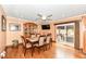 Dining room features wood floors, modern lighting, and a sliding door leading to outdoor seating at 4080 Wander Way, Greenwood, IN 46142