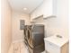 Well-lit laundry room equipped with modern washer, dryer, utility sink, and ample storage space at 4080 Wander Way, Greenwood, IN 46142