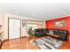 Inviting living room with a black leather sectional, hardwood floors, and an entryway at 4080 Wander Way, Greenwood, IN 46142