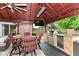 Outdoor kitchen under a gazebo with a built-in grill, mini-fridge, and comfortable seating at 4080 Wander Way, Greenwood, IN 46142