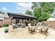 Outdoor seating area featuring plush chairs, a built-in grill, and a fire pit at 4080 Wander Way, Greenwood, IN 46142