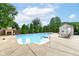 Backyard pool area with a wooden fence, lush trees, and a storage shed at 4080 Wander Way, Greenwood, IN 46142