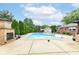Backyard swimming pool with a stone fireplace and meticulously landscaped surroundings at 4080 Wander Way, Greenwood, IN 46142