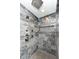 Bathroom showcases modern black marble tiling, sleek fixtures, and rainfall shower-head offer a spa-like experience at 4080 Wander Way, Greenwood, IN 46142