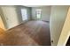 A carpeted bedroom offers a blank canvas with neutral walls, a large window, and ample natural light at 4408 Clovelly Ct, Indianapolis, IN 46254