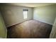 A carpeted bedroom offers a blank canvas with neutral walls, a large window, and ample natural light at 4408 Clovelly Ct, Indianapolis, IN 46254