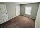 A carpeted bedroom offers a blank canvas with neutral walls, a large window, and ample natural light at 4408 Clovelly Ct, Indianapolis, IN 46254