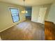 Bright dining room featuring a window, elegant chandelier, and neutral walls, perfect for Gathering meals at 4408 Clovelly Ct, Indianapolis, IN 46254