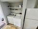 Efficient laundry area with washer, dryer, and refrigerator, maximizing space and functionality at 4408 Clovelly Ct, Indianapolis, IN 46254