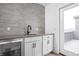 Stylish wet bar featuring gray subway tile backsplash, white cabinets, and stainless steel beverage cooler at 443 Flora Pl, Carmel, IN 46290