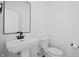 Modern bathroom featuring a sleek pedestal sink and minimalist design with white walls at 443 Flora Pl, Carmel, IN 46290