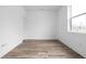 Clean, minimalist room featuring wood floors, white walls, and a bright window at 443 Flora Pl, Carmel, IN 46290