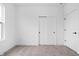 Bright bedroom with soft carpet, modern sliding closet doors, and a well-lit atmosphere at 443 Flora Pl, Carmel, IN 46290