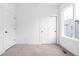 Neutral bedroom with a window and closet doors, showcasing a clean and bright interior at 443 Flora Pl, Carmel, IN 46290