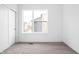 Cozy bedroom with neutral carpet, a large window and a modern sliding closet door at 443 Flora Pl, Carmel, IN 46290