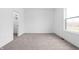 Bright bedroom featuring plush carpet, neutral paint, and a walk-in closet at 443 Flora Pl, Carmel, IN 46290