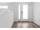 Bright entryway with white walls, wood-look flooring, and a modern front door at 443 Flora Pl, Carmel, IN 46290