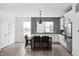 Bright, modern kitchen with white cabinets, a large island, and stainless steel appliances at 443 Flora Pl, Carmel, IN 46290