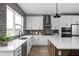 Well-lit kitchen featuring white cabinets, stainless steel appliances, and gray brick backsplash at 443 Flora Pl, Carmel, IN 46290